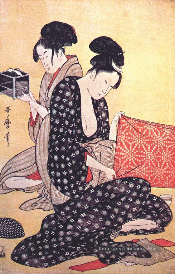 femmes faisant des robes 1 Kitagawa Utamaro ukiyo e Bijin GA Peintures à l'huile
